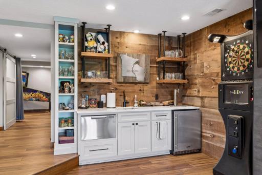 Here you can see where some of the cool add-ins were put in. There is a custom wet bar that offers both a beverage drawer and kegerator! Also included is the cabinet space which is ideal for organization and storage!