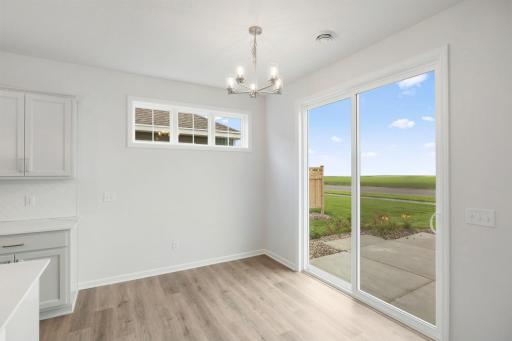 Dining area is light and bright with cute piano windows and an extra tall oversized patio door- let the sun shine in!