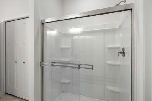 60 inch oversized shower with a semi framelss glass shower door.