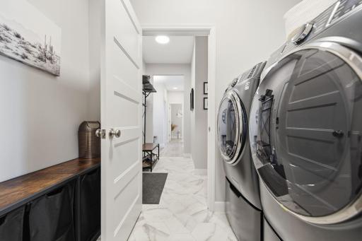 Laundry is attached to the primary closet and neighbors the mud room.