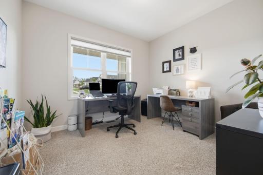 The front flex/office/den/exercise room/music room peeks over the covered front porch.