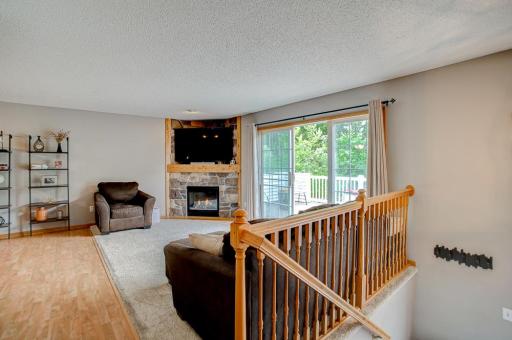 Living room with gas burning fireplace and updated stone surround
