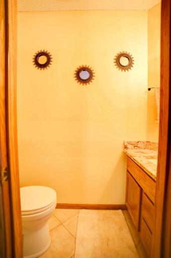 Main floor half bath with updated quartz countertop, updated sink and faucet