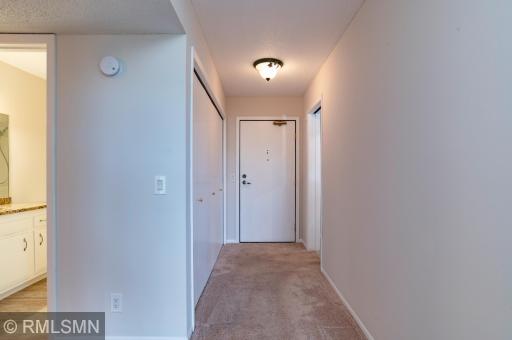 Front hall inside the unit depicts a row of closets.