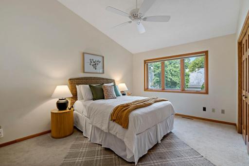 The primary bedroom features vaulted ceiling with fan.