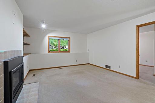 The lower level family room has a cozy gas fireplace. The large window makes this a lovely space to hang out.