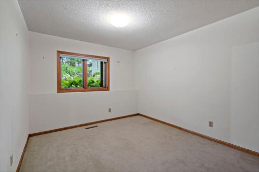 The third bedroom, located in the lower level looks out the the lush back garden.