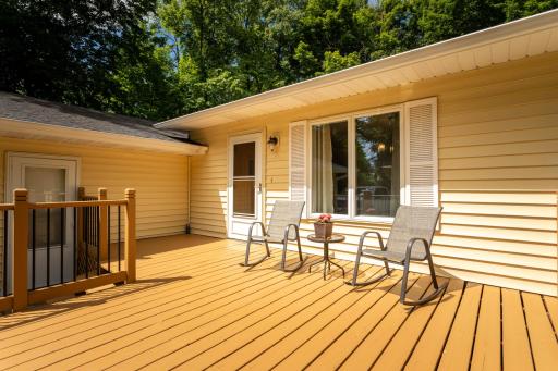 Large front deck to sit and enjoy a large lot with mature trees
