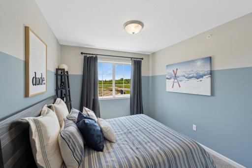Bedroom 2 - photos of are a staged model home of the same floorplan. Colors and selections may differ.