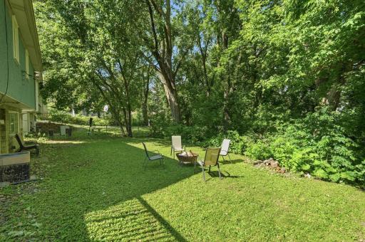 Back yard w/wall of trees for privacy. Yard extends down hill creating your own little wooded area to explore!