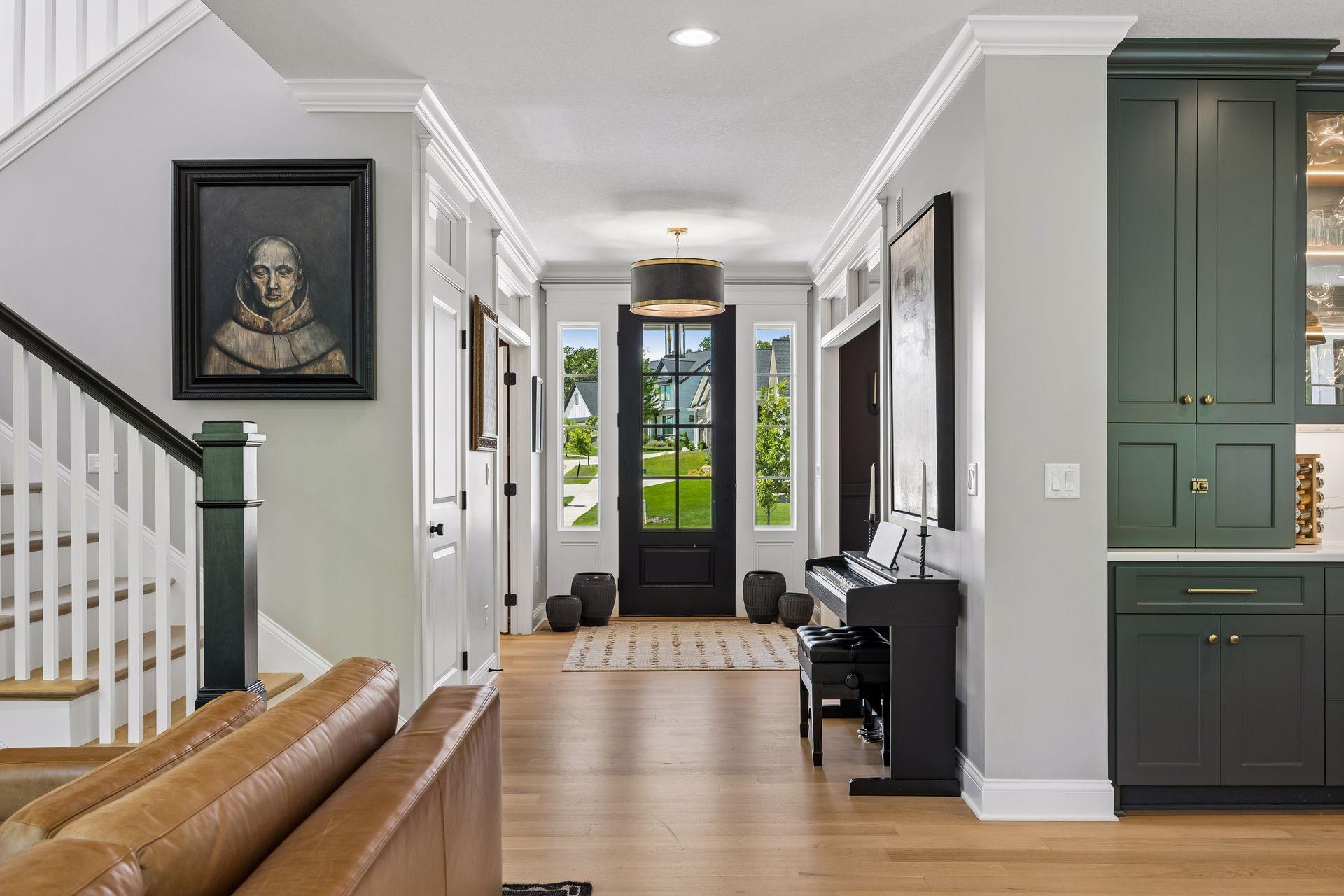 A dramatic front entry framed by oversized windows creates a bright and welcoming first impression.