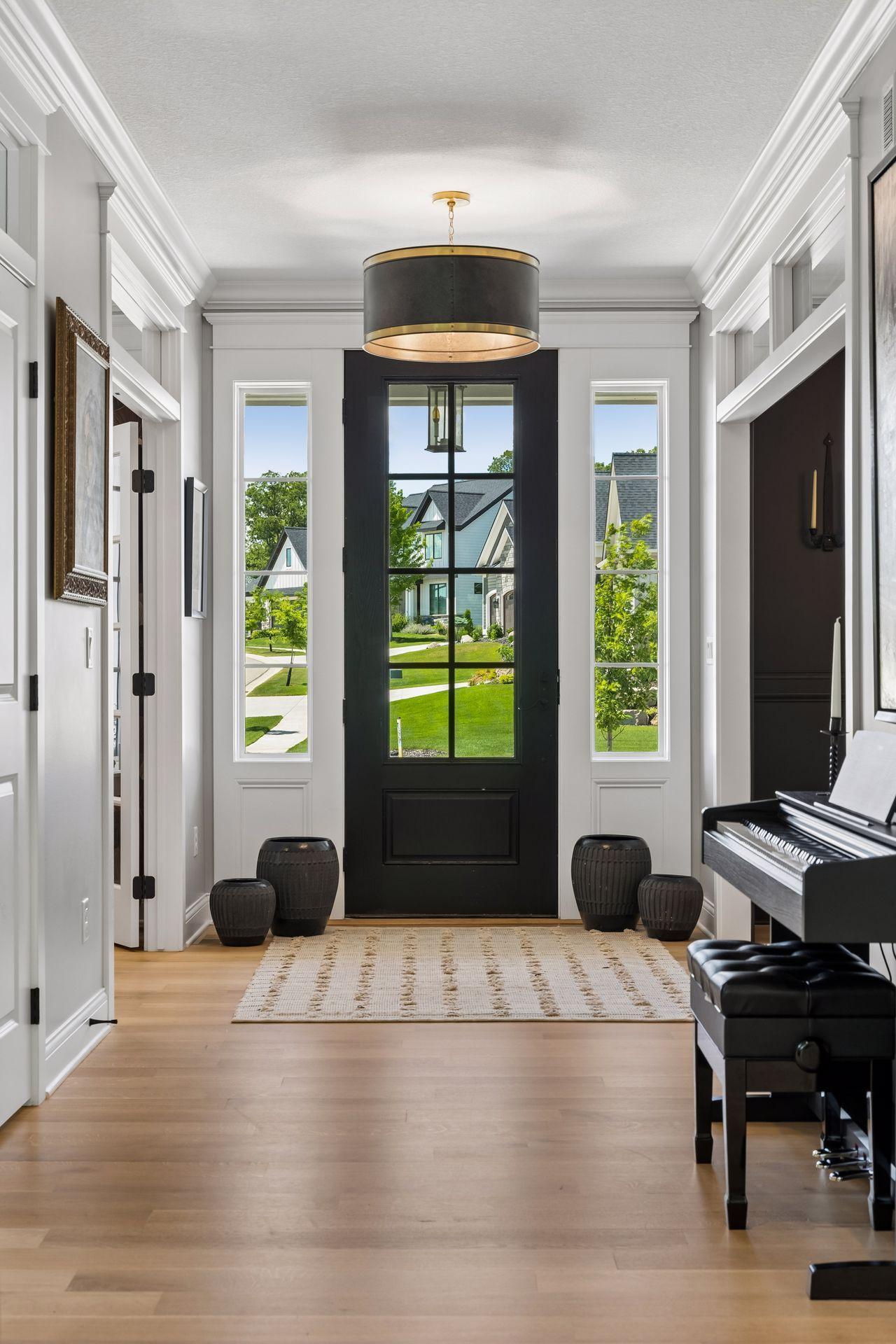 An elegant foyer introduces the home's thoughtful design with hardwood floors, extensive millwork, abundant natural light, and beautiful sightlines throughout the main level.
