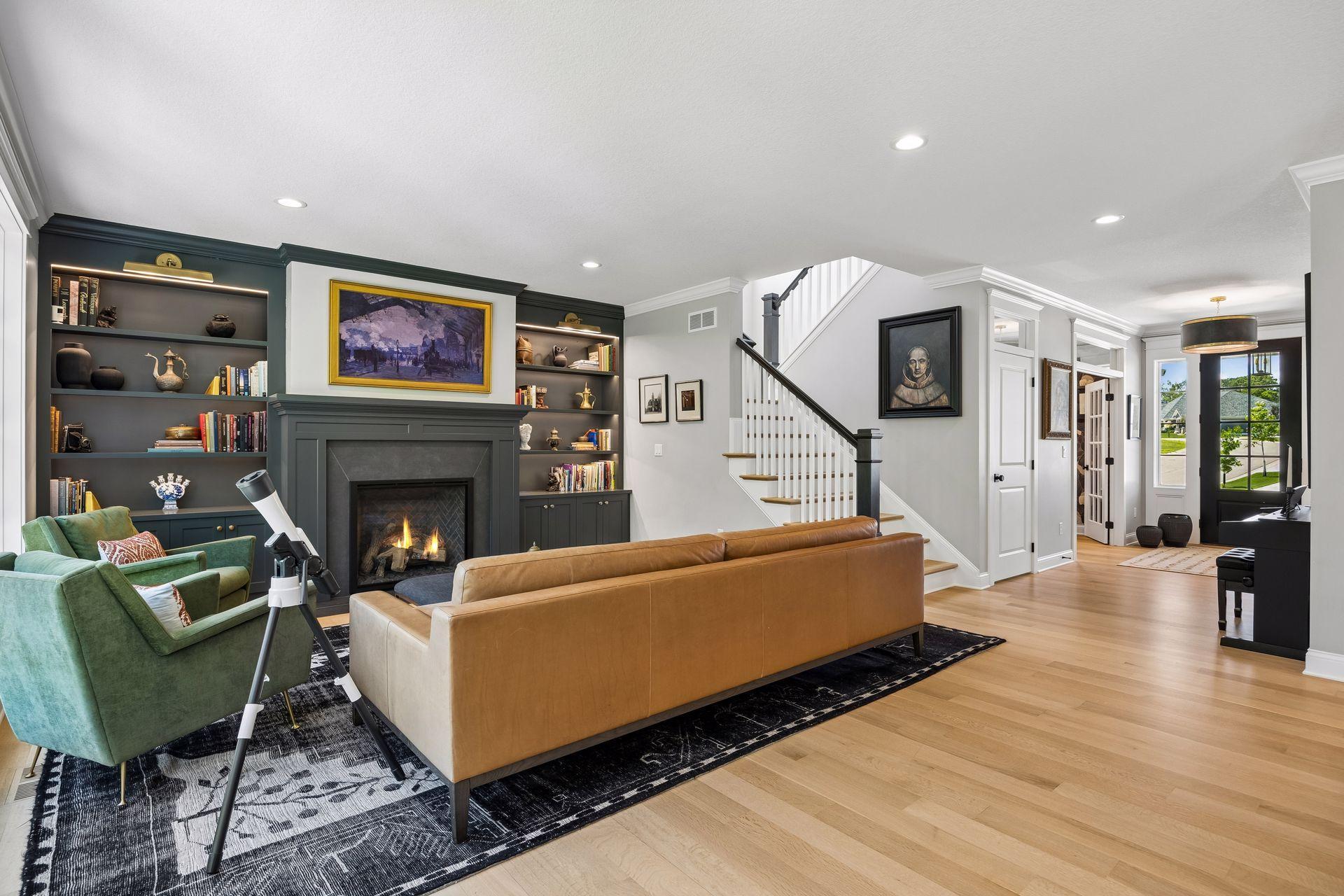 The heart of the home features custom built-ins, a statement fireplace, designer lighting, and an effortless flow into the surrounding living spaces.