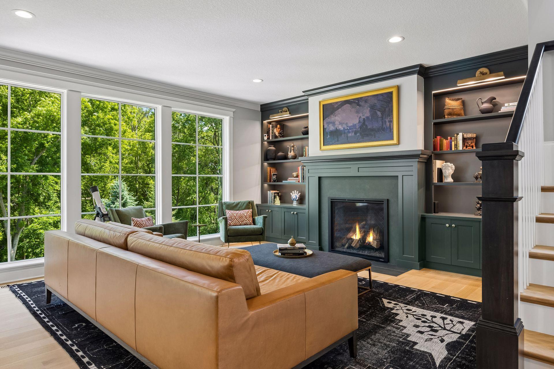 Walls of oversized windows frame peaceful wooded views while filling the home with natural light year-round.