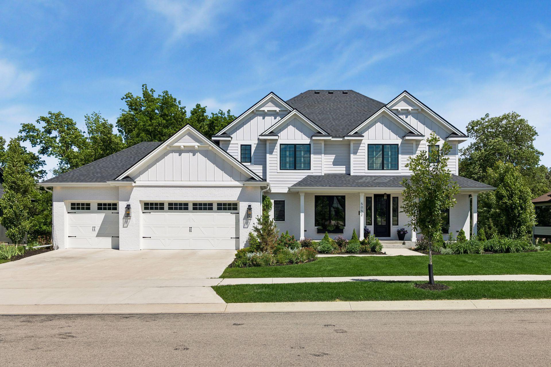 Magazine-worthy curb appeal featuring timeless architecture, manicured landscaping, and a welcoming front porch designed to make a lasting first impression.