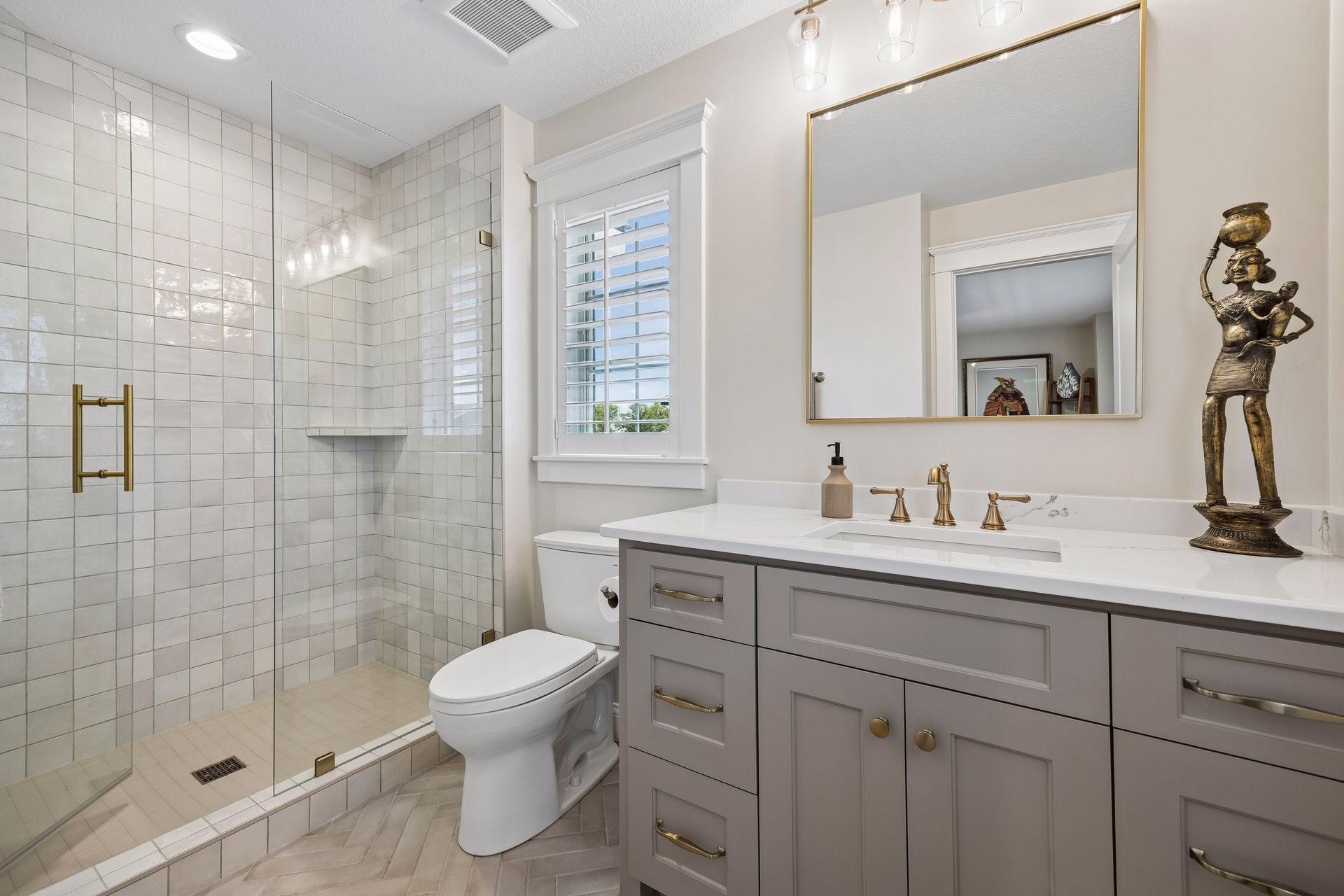 Beautifully tailored with floor-to-ceiling tile, quartz surfaces, and warm brass accents, creating a boutique hotel experience.