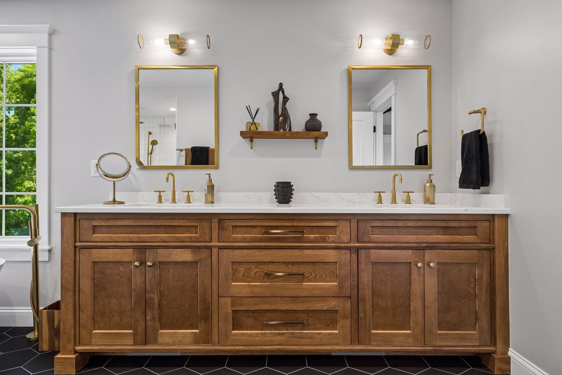 An expansive dual vanity showcases furniture-quality cabinetry paired with elegant brass fixtures and timeless detailing.