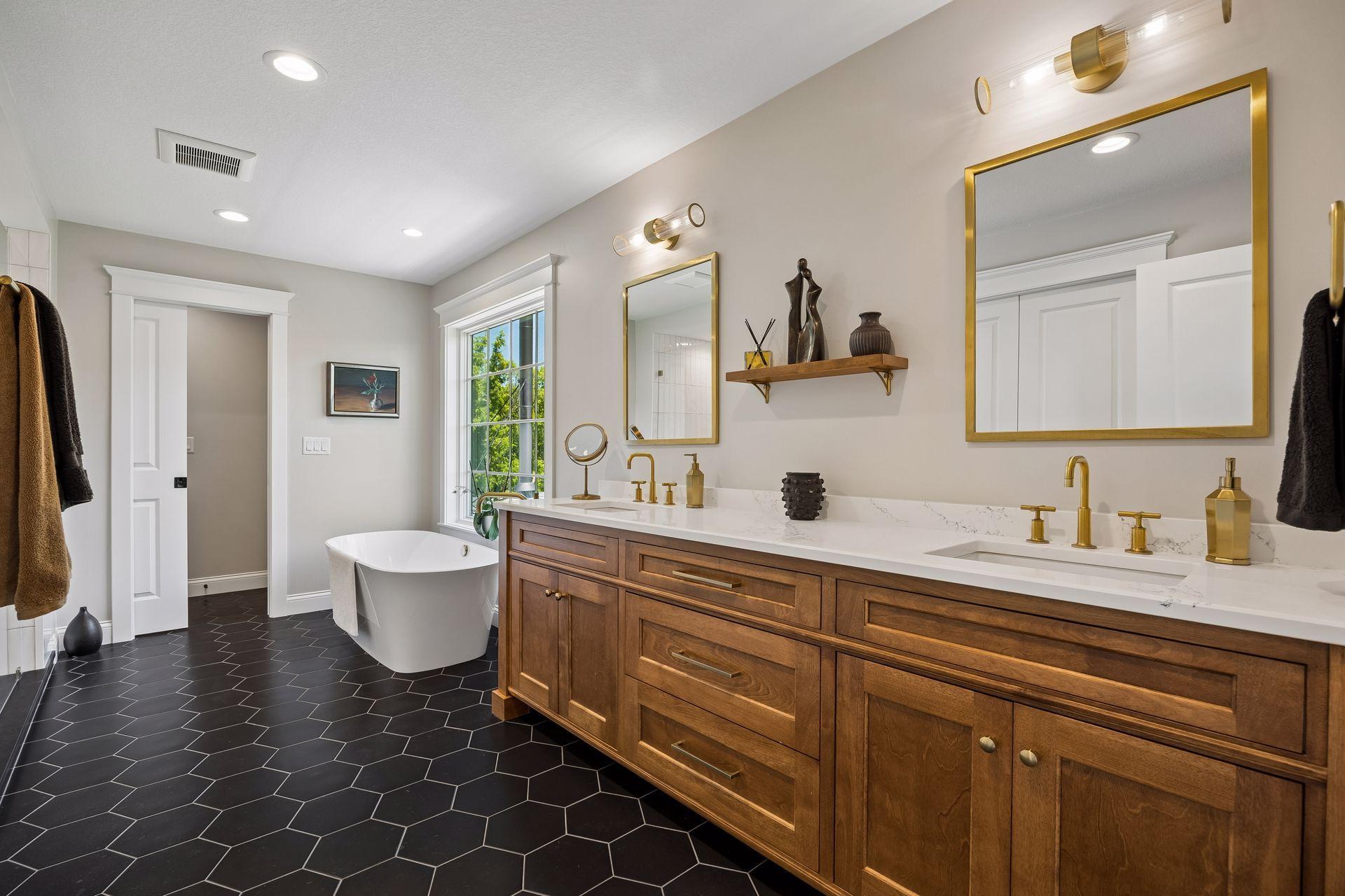 A spa-inspired bath featuring custom walnut cabinetry, quartz surfaces, designer lighting, and a luxurious freestanding soaking tub.