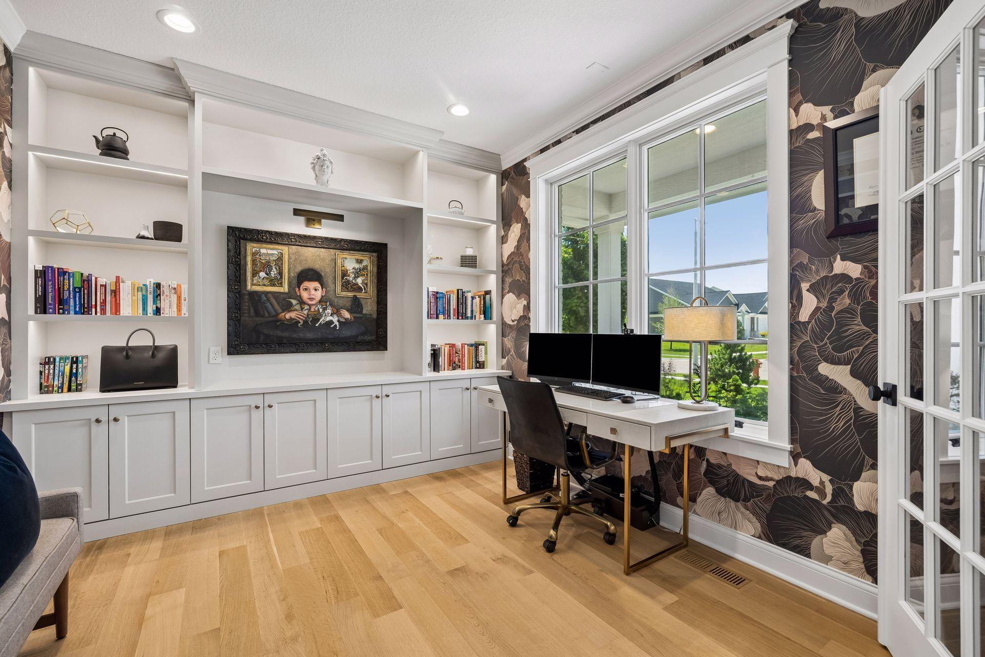A true executive office featuring custom built-ins, integrated workspace, and oversized windows that flood the room with natural light.