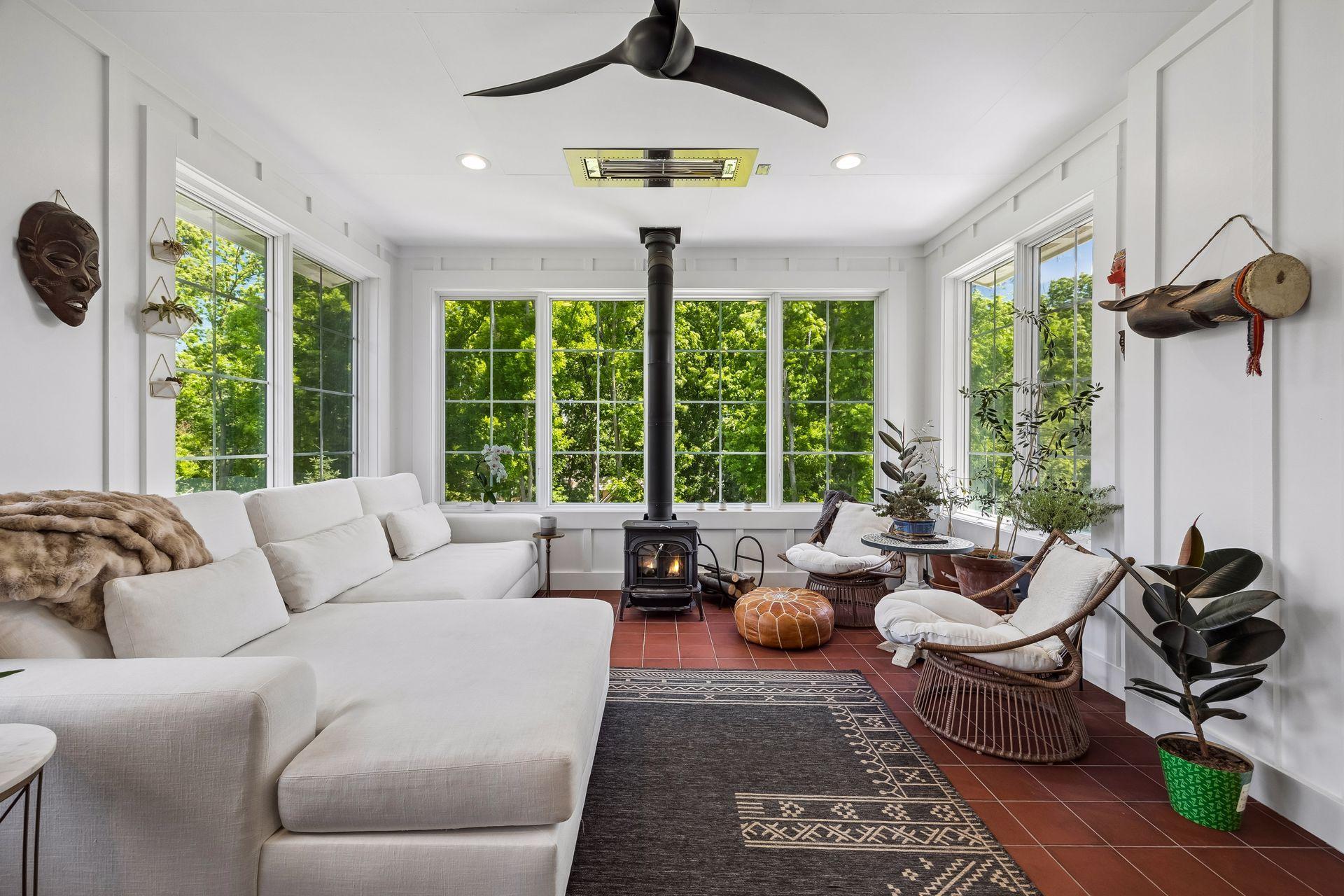 A favorite gathering space complete with infrared heat, wood-burning fireplace, and panoramic woodland views.
