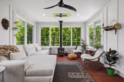 A favorite gathering space complete with infrared heat, wood-burning fireplace, and panoramic woodland views.