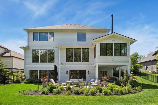 Large expanses of glass flood the home with natural light while capturing peaceful wooded views from nearly every level.