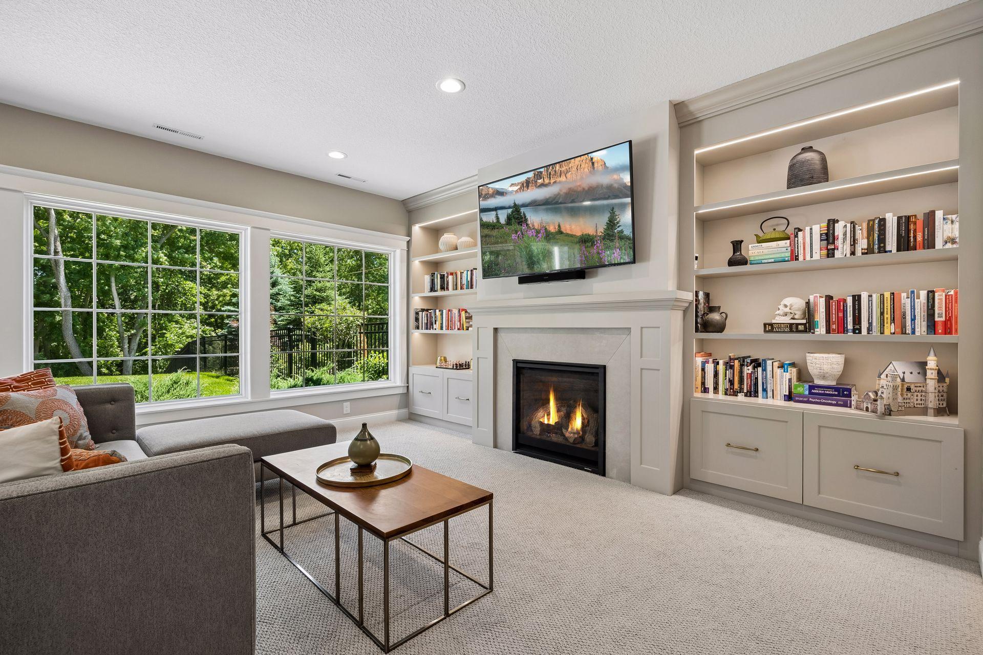 Custom illuminated built-ins and a beautifully detailed fireplace create a sophisticated gathering place for every season.