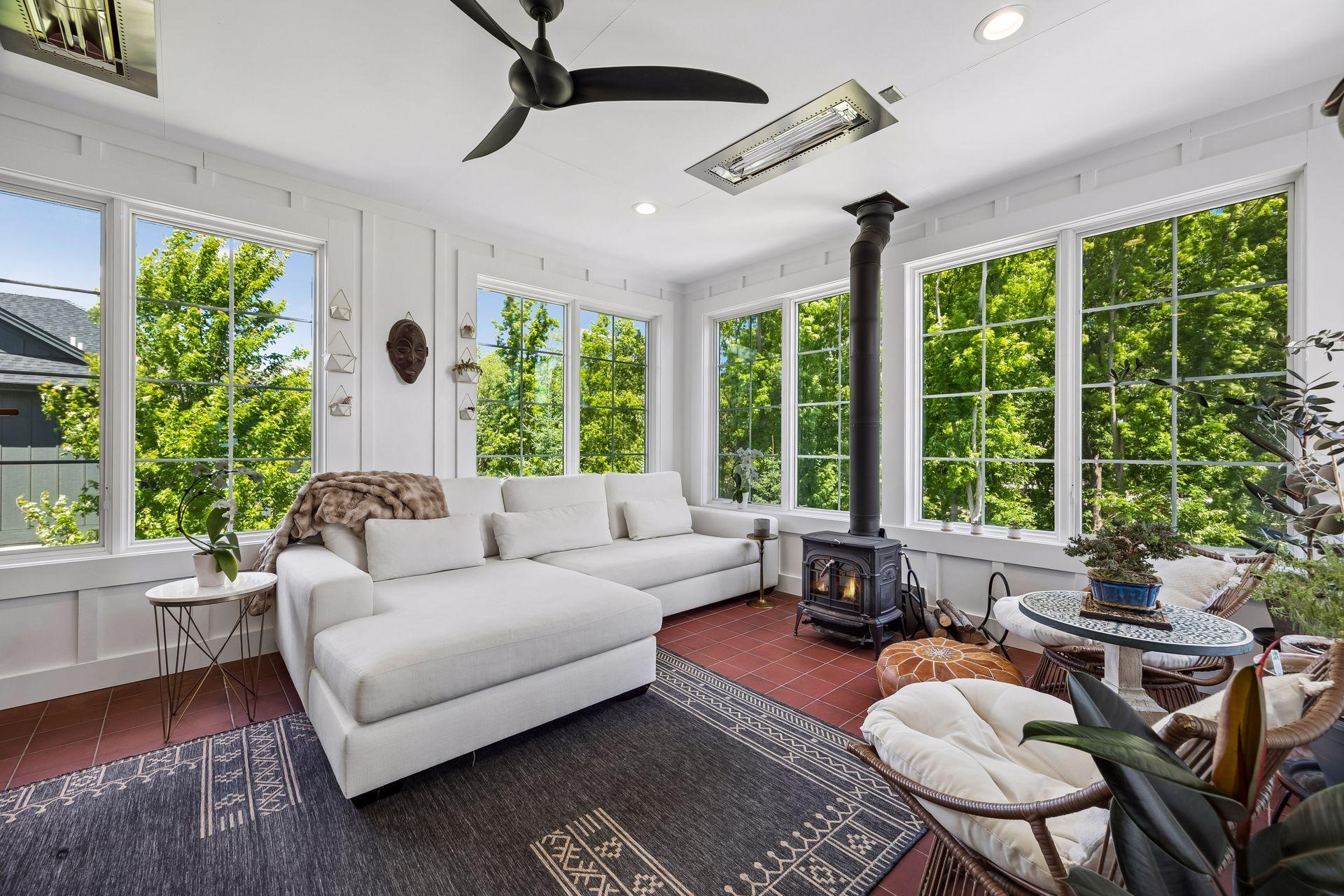 An extraordinary three-season sanctuary surrounded by walls of glass, inviting nature inside year-round.