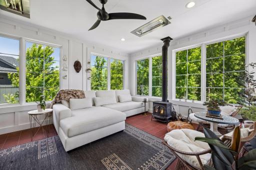 An extraordinary three-season sanctuary surrounded by walls of glass, inviting nature inside year-round.