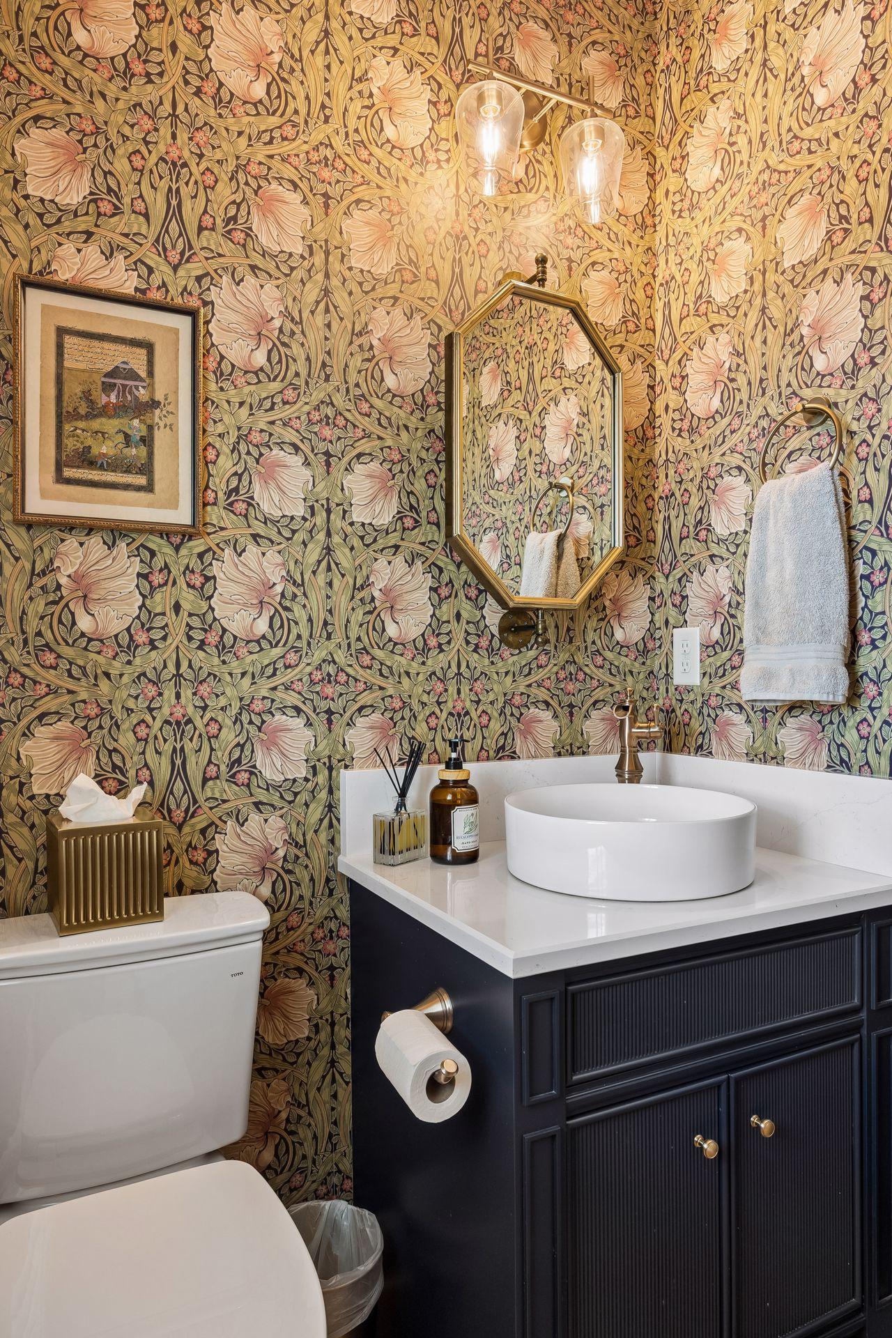 Wrapped in dramatic designer wallpaper and accented with rich brass fixtures, the powder room offers a memorable boutique-hotel experience.