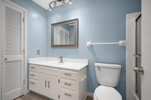 Full bathroom featuring a modern vanity with ample storage and clean, contemporary finishes.