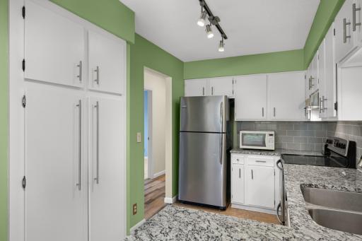 Abundant storage awaits with oversized pantry cabinets and ample kitchen cabinetry throughout.