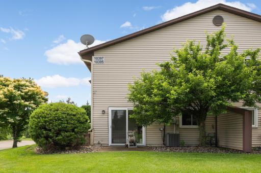 Peaceful outdoor setting with direct walkout access and beautiful mature trees providing added privacy and shade.