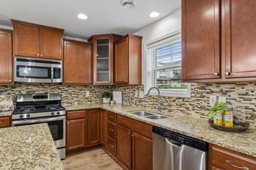 Beautiful kitchen with loads of cabinet space, center island with breakfast bar, and stainless appliances.