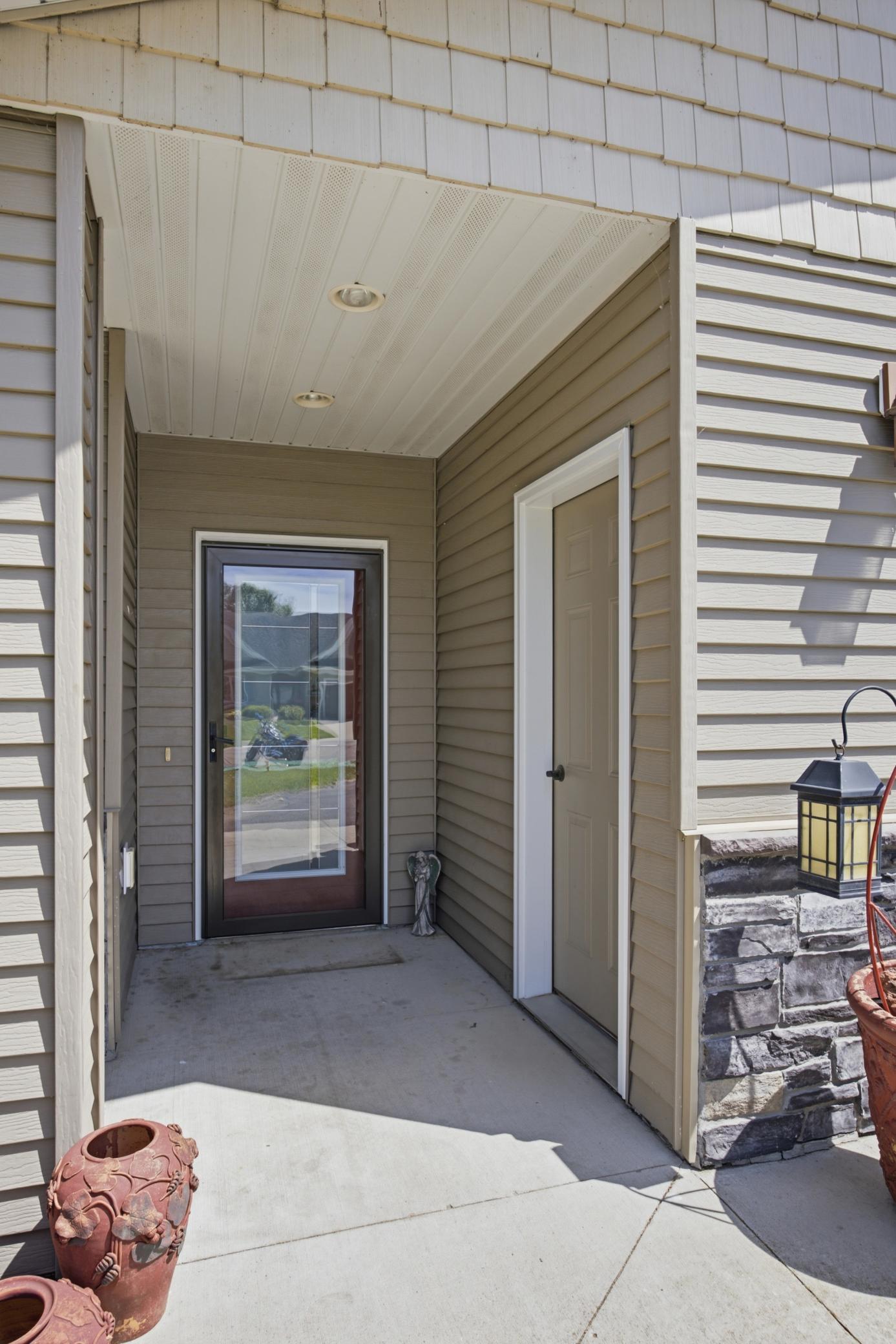 Covered Front Entry & Service door to heated garage