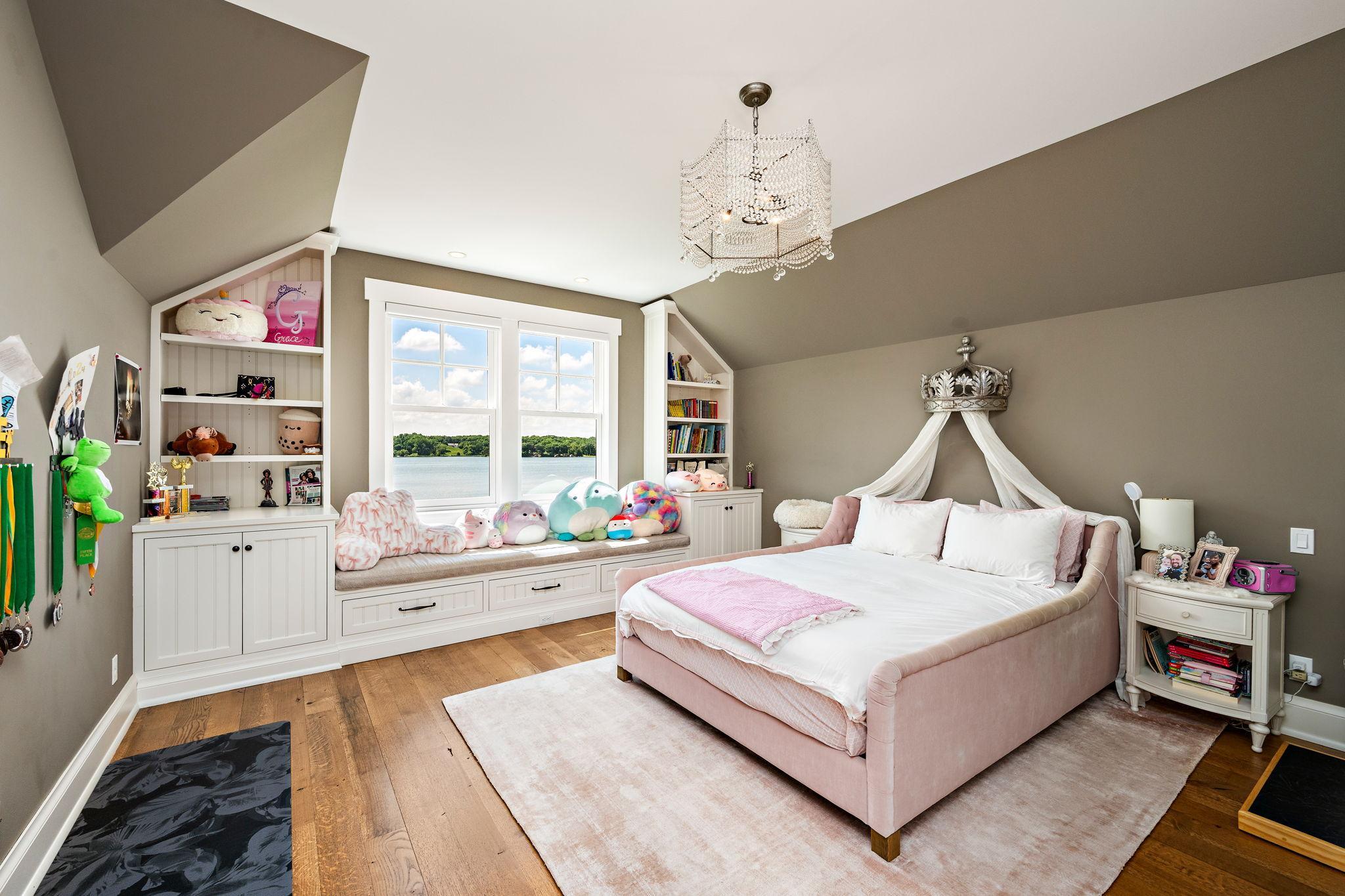 Upper level bedroom with lake views and en suite bath