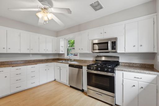 The light and bright kitchen offers loads of cabinet and counter space.