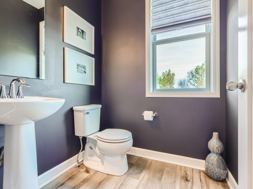 Photo is of the actual model. Powder room on the main floor has a cute flair with name brand faucets and fixtures.