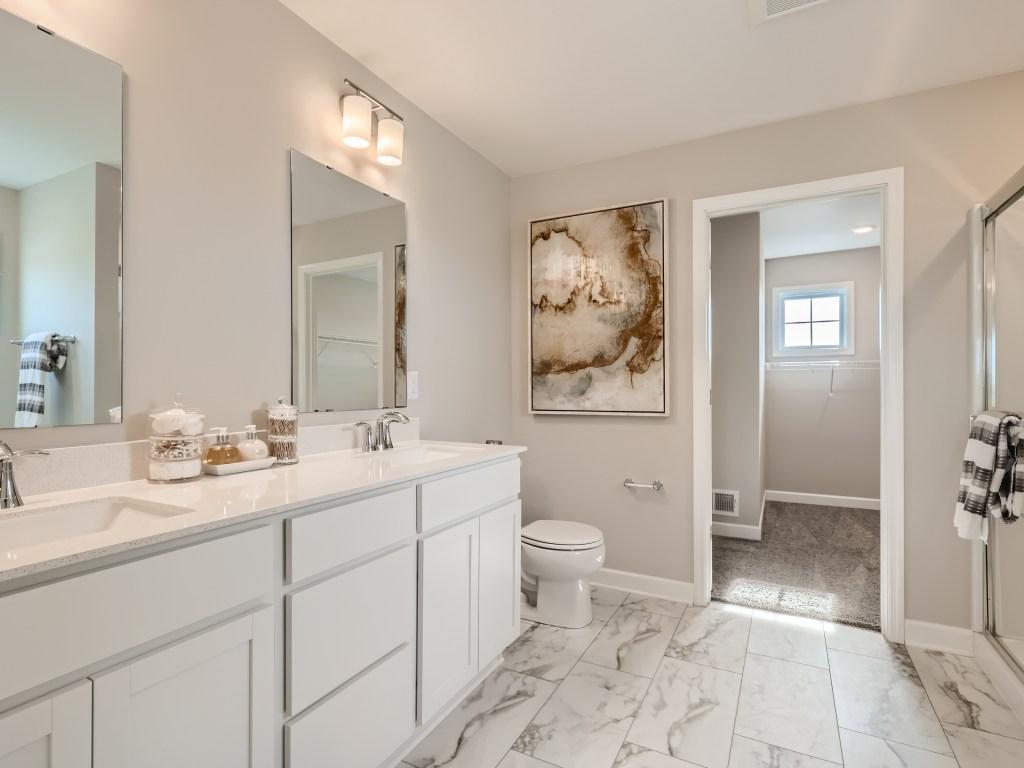 Photo is of the actual model. Elegant primary bath with dual vanity, separate shower and tub!