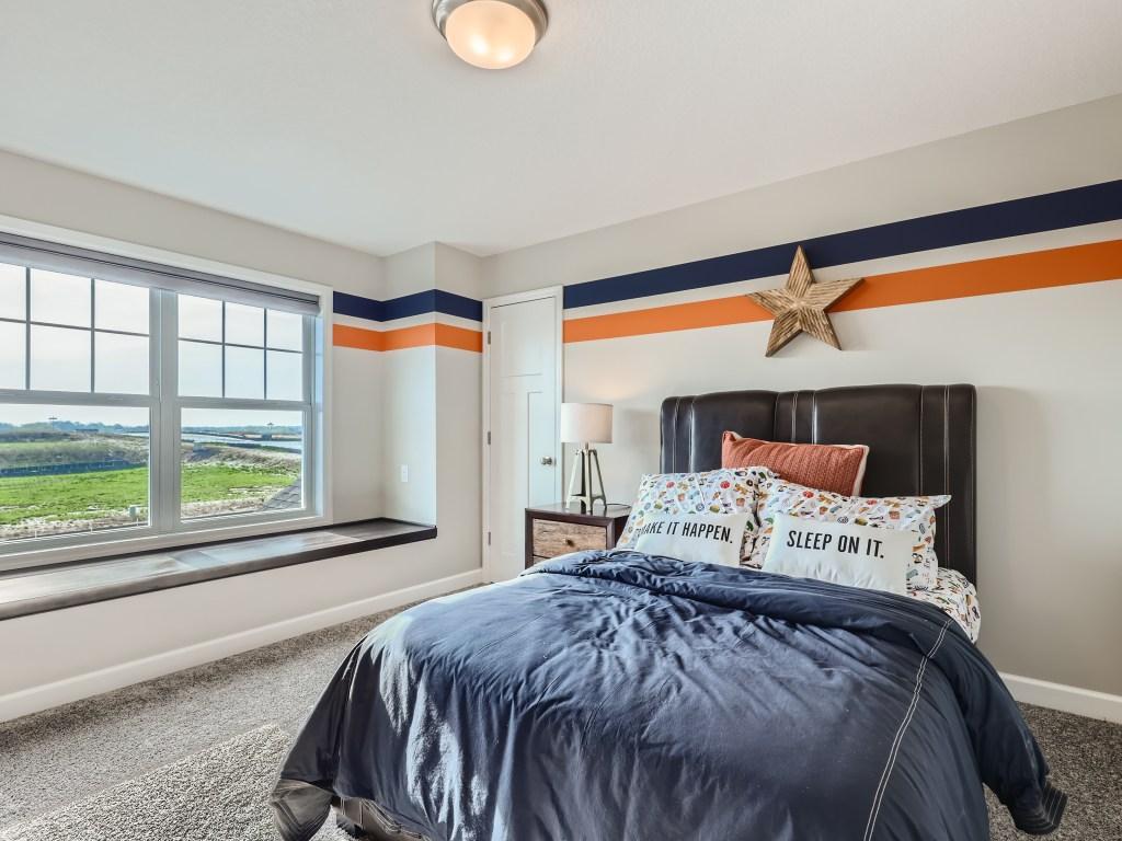 Photo is of the actual model. Upper level secondary bedrooms all with walk-in closets and this one even has a window seat.