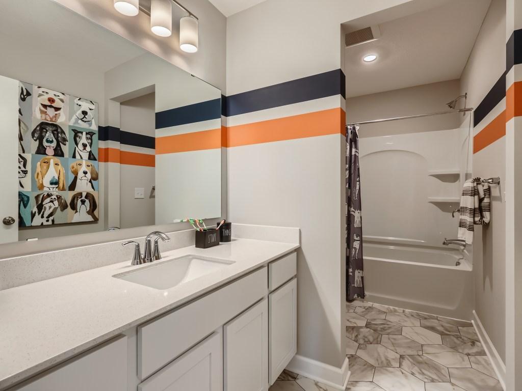 Photo is of the actual model. The upper level secondary bathroom.