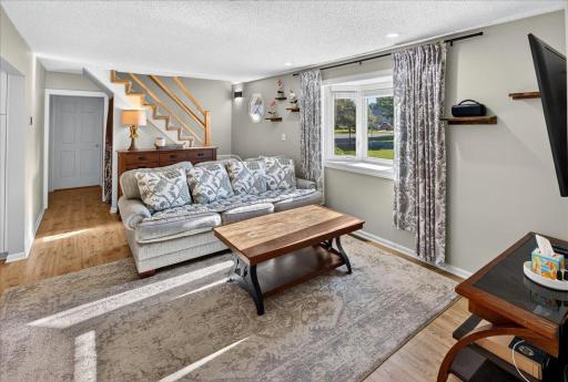 Enjoy a sun-filled living room with a picture-perfect window, offering a warm and inviting space to gather and create lasting memories.