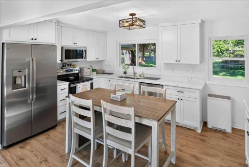 Enjoy a stylish, contemporary kitchen with stainless steel appliances, stone countertops, and generous cabinetry, including a wall pantry and a convenient coffee bar area.