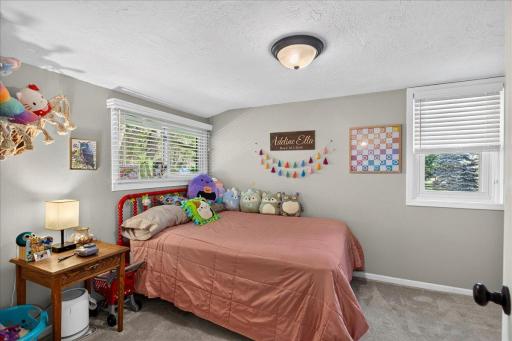 Bright, spacious second bedroom with neutral tones, updated windows, and turnkey readiness.