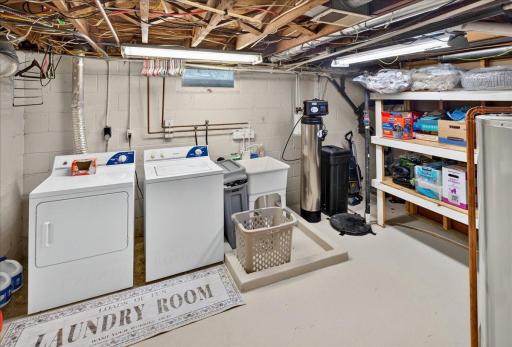 Bright and tidy laundry room featuring ample storage and plenty of space for organization and efficiency.