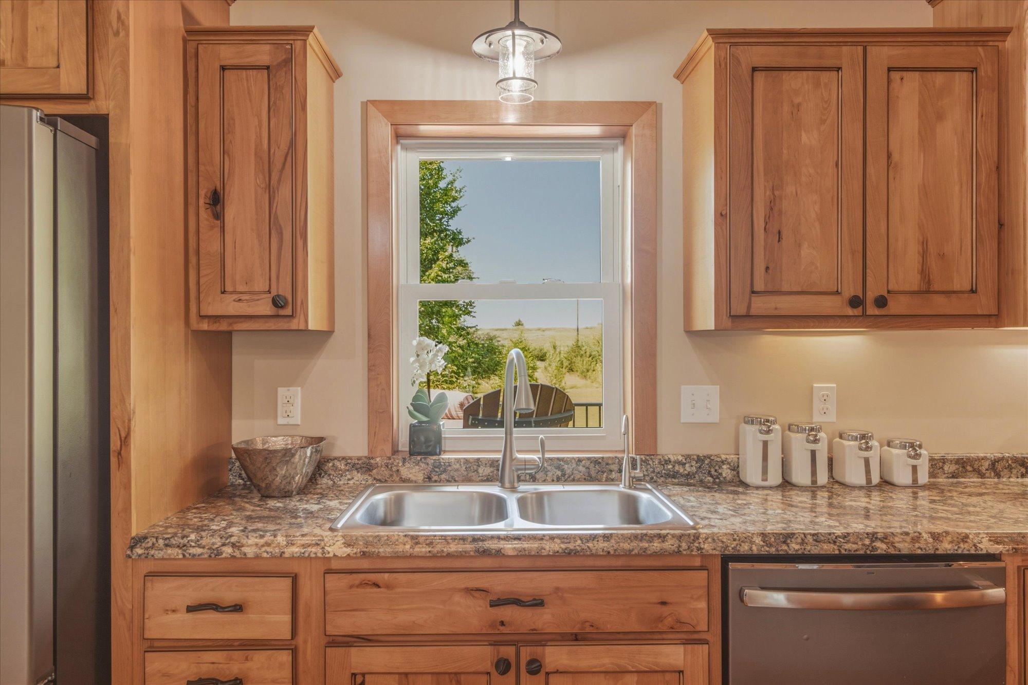 Enjoy the view of your serene backyard while preparing in your custom kitchen