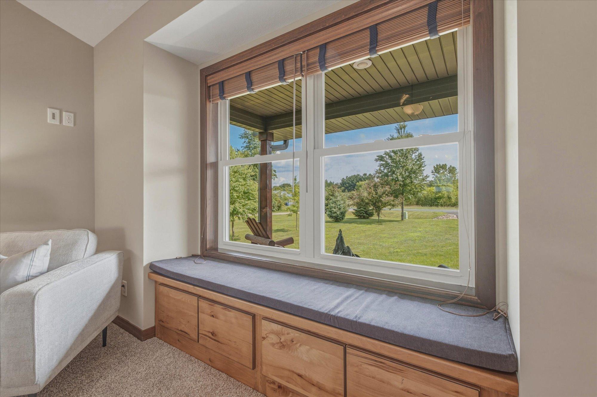 Built in Window Seat overlooks the well manicured front lawn - a perfect reading nook