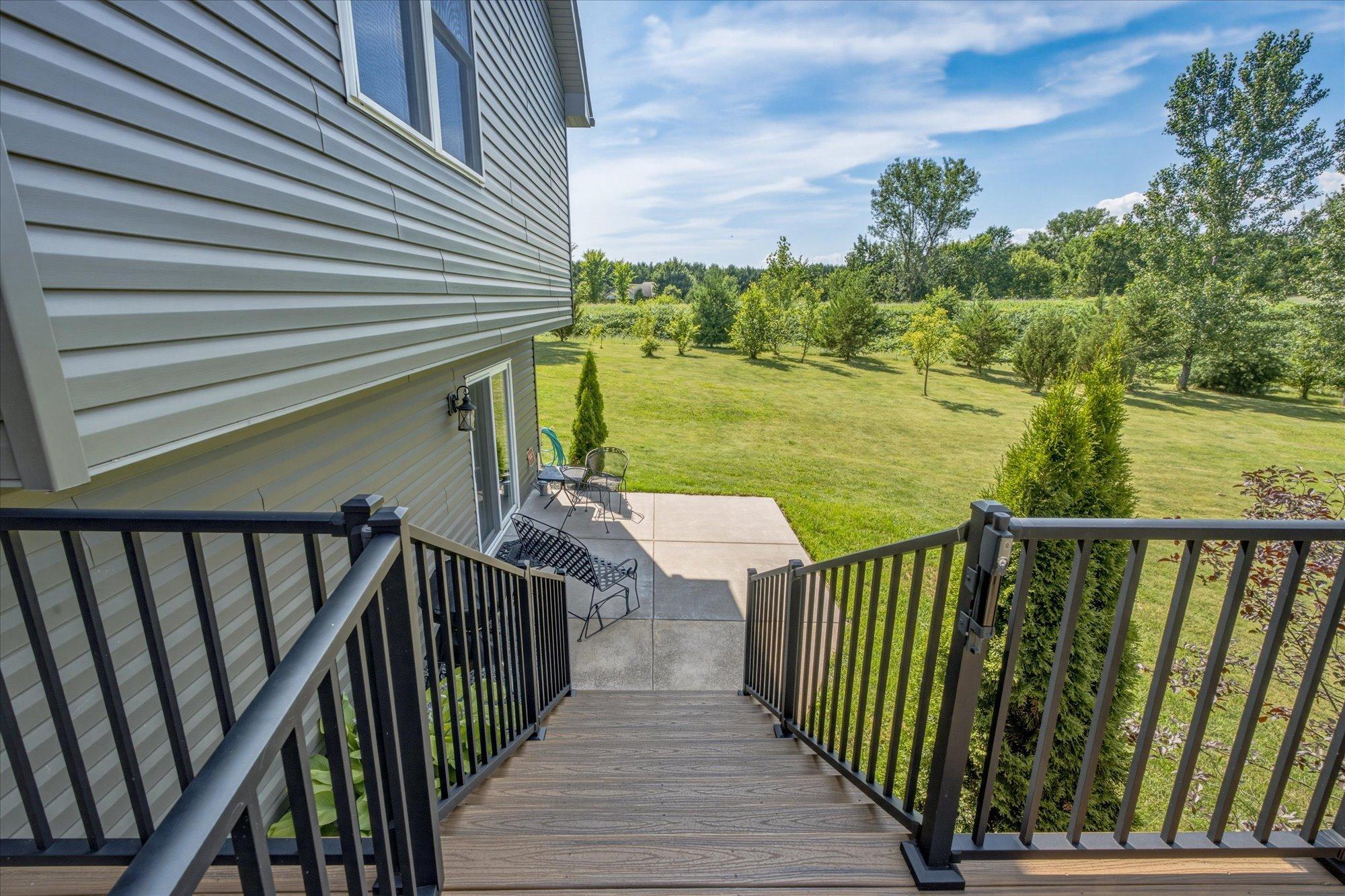 Stairs from the deck lead to the lower patio