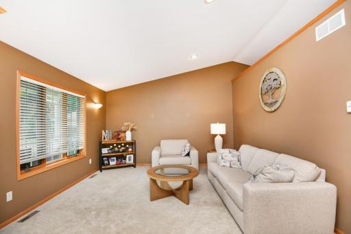 The main floor living room has open views to the entry, and even to the dining and great room while maintaining it's cozy separate space for reading a good book