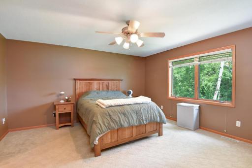 The primary bedroom suite offers a respite from the day, complete with private whirlpool bath